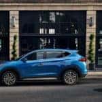 The 2021 Hyundai Tucson parked in front of a store.