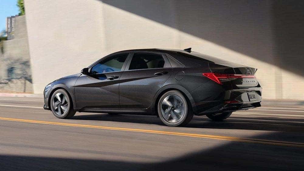 The 2021 Hyundai Elantra driving under a bridge.
