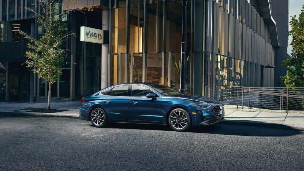 The 2021 Hyundai Sonata parked in front of a building.