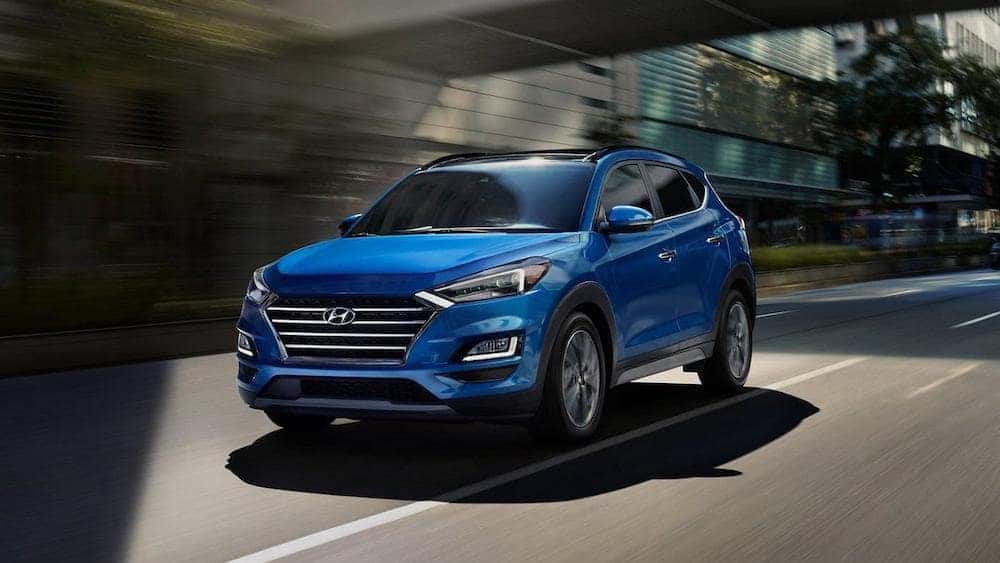 The 2021 Hyundai Tucson driving in a city.
