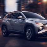 The 2022 Hyundai Tucson making a turn in a city.