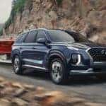 The 2021 Hyundai Palisade towing a red boat.