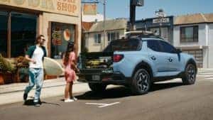 People loading up the 2022 Hyundai Santa Cruz to surf near Orlando.