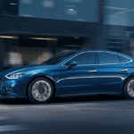 The 2022 Hyundai Sonata driving through a city like Orlando.