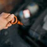Using a dip-stick to check the oil level in a VW Passat