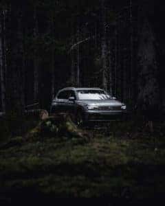 A shiny gray 2021 Volkswagen Tiguan Towing SUV sits in the woods in Marion, IL.