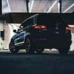 A 2021 Volkswagen Tiguan drives through a parking garage