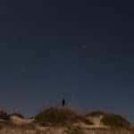 A man stands on a rock while stargazing in Marion, IL