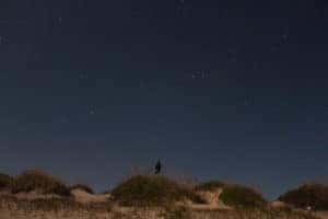A man stands on a rock while stargazing in Marion, IL