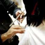 A woman has her hair cut at a salon in Marion, IL