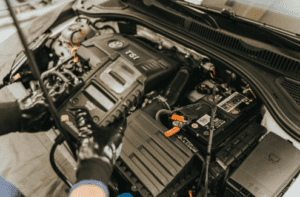 Volkswagen service mechanic testing a vw car battery in Marion, IL.