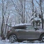 A vehicle is set up with car accessories for camping in Marion during winter