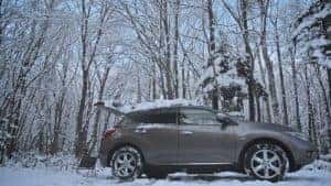A vehicle is set up with car accessories for camping in Marion during winter