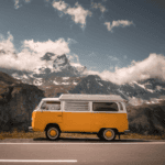 white and orange van on gray asphalt road during daytime