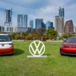 The Volkswagen ID. Buzz and ID. 4 electric vehicles sit by the Volkswagen logo in Illinois