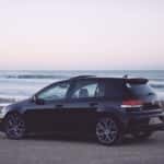 A traded in Volkswagen parked on a beach