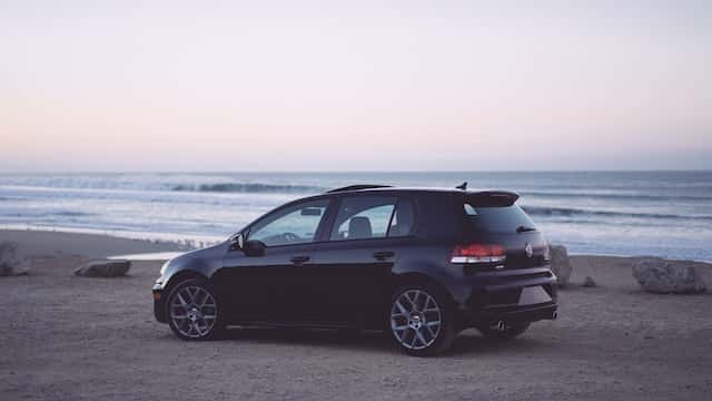 A traded in Volkswagen parked on a beach