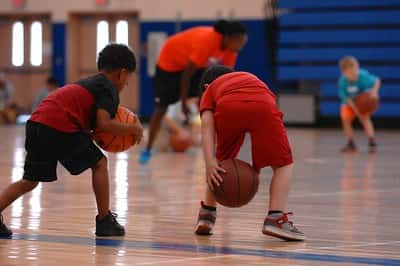 Children learn how to play basketball at a youth sports program in Marion, Illinois