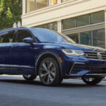2024 Volkswagen Tiguan exterior in blue paint color on city street in Marion, IL.