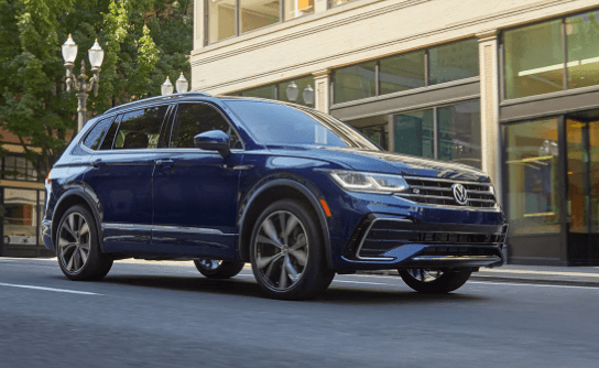 2024 Volkswagen Tiguan exterior in blue paint color on city street in Marion, IL.