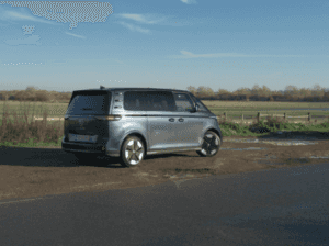 Volkswagen ID Buzz electric vehicle parked alongside an open pasture.