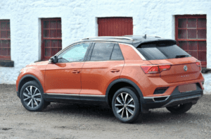 Volkswagen of Tiguan in orange paint photographed from the rear.