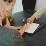 people signing paperwork at the Volkswagen of Marion dealership in Marion, IL