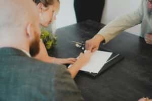 people signing paperwork at the Volkswagen of Marion dealership in Marion, IL
