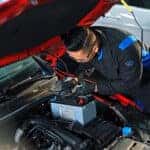 Volkswagen mechanic replacing a car battey
