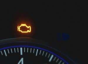 orange check engine light on a car dashboard