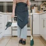 a person with cleaning supplies