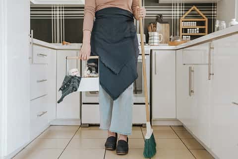 a person with cleaning supplies