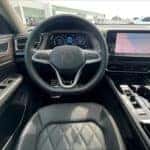 driver's seat view of the steering wheel and dashboard on a VW Atlas