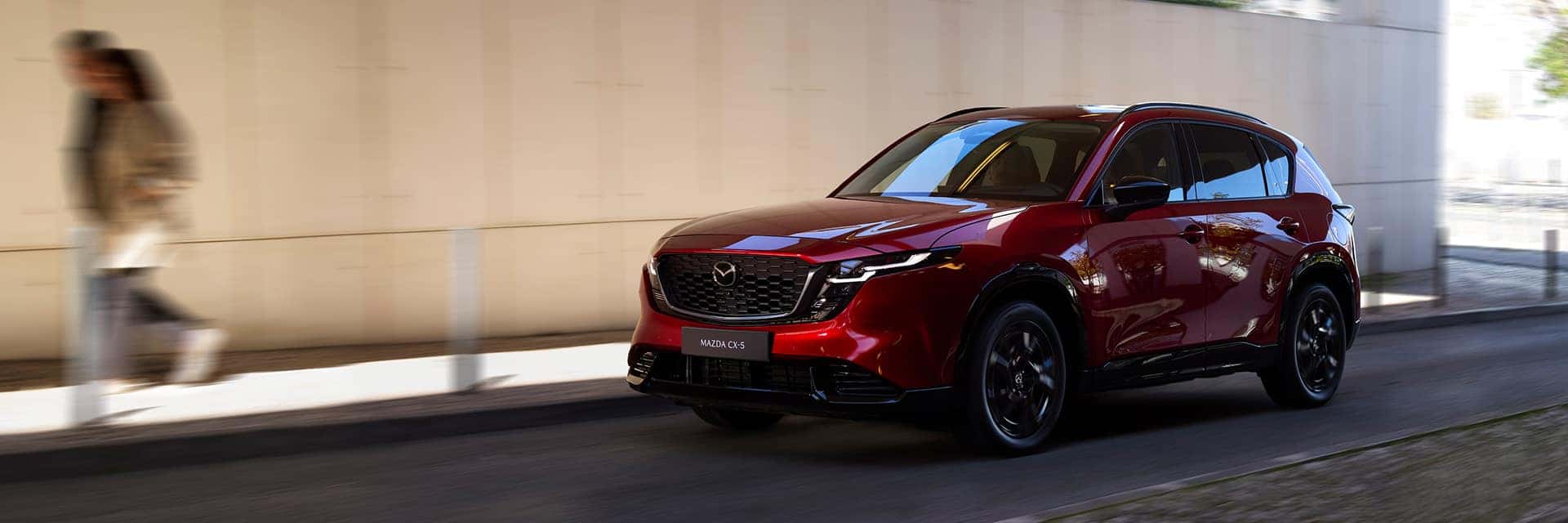red mazda cx-5 driving on road