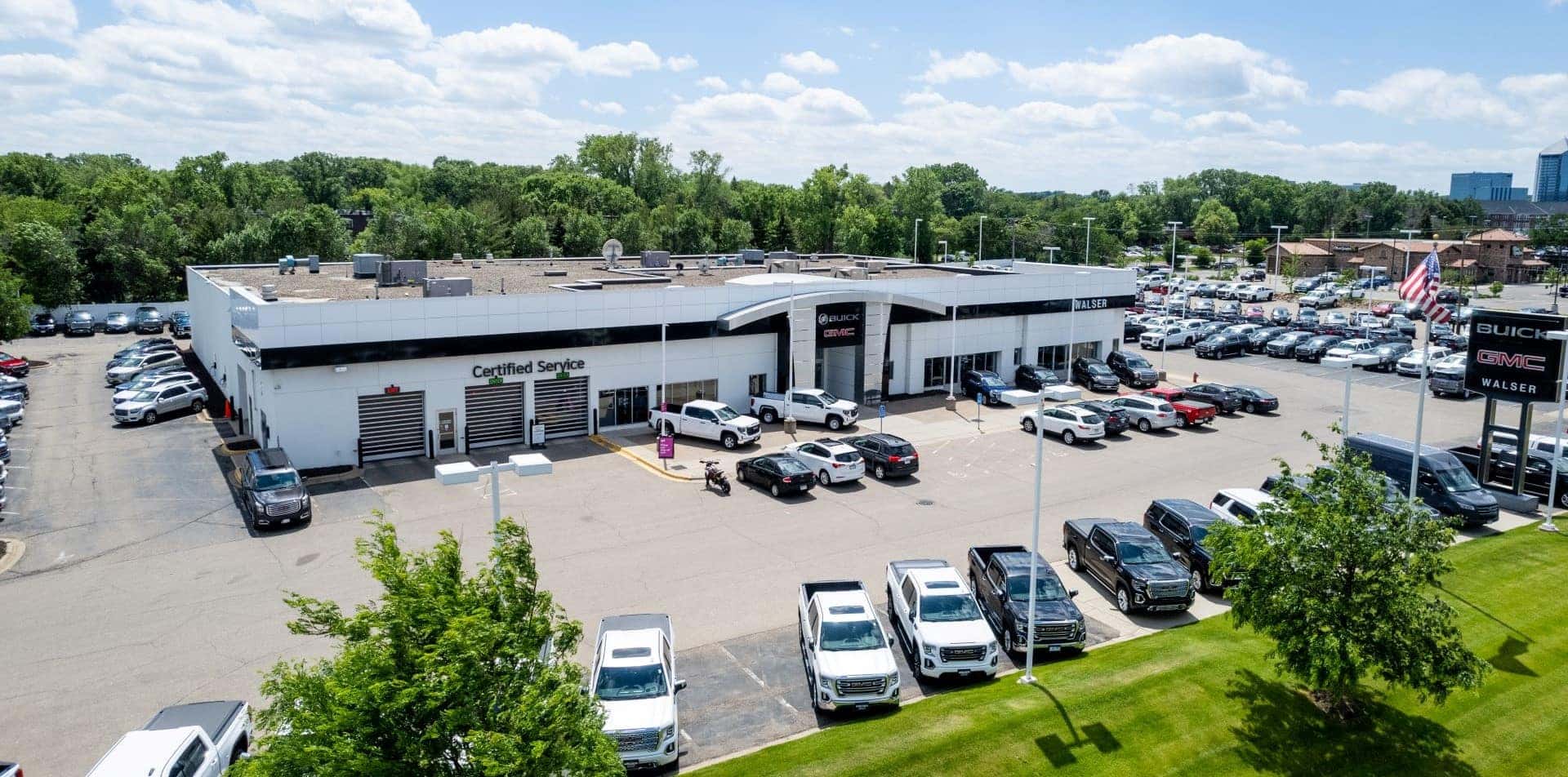 An exterior shot of a Buick GMC dealership during the day