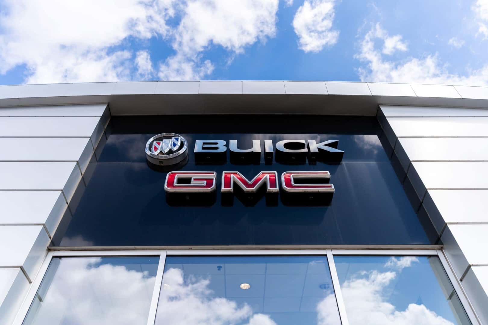 Buick GMC dealership logo with sky in background.