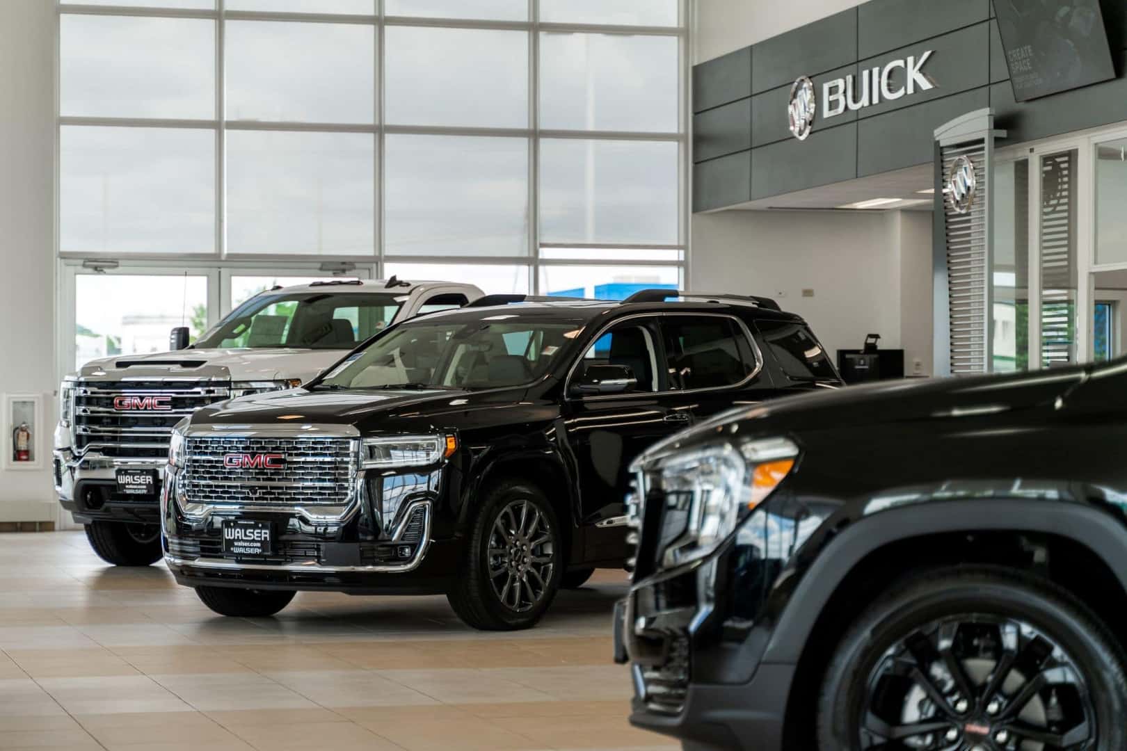 New GMC Trucks and SUVs on a show floor.